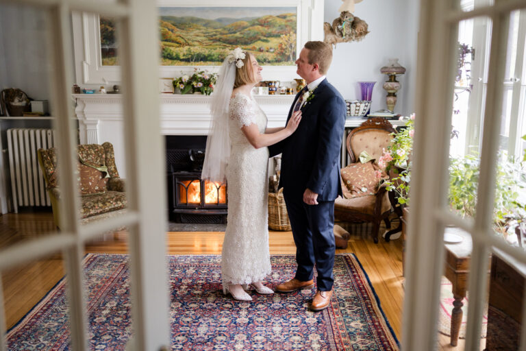 A bride and groom seen through a set of doors at Gloriosa & Co. in Ashfield, MA