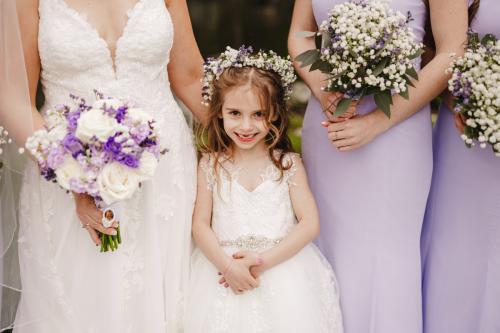 A little girl in a lavender dress with her bridesmaids captured by a Western MA wedding photographer.