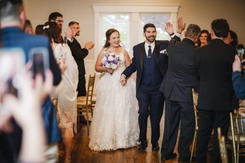 A Western MA Wedding Photographer captures the special moment of a bride and groom walking down the aisle at their wedding.