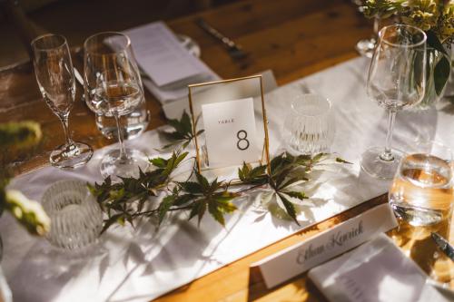 As a Western MA Wedding Photographer, I capture exquisite details like a table setting with a table number and a glass of wine.