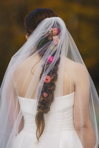 A bride in a wedding veil with flowers in her hair captured by a talented Western MA Wedding Photographer.