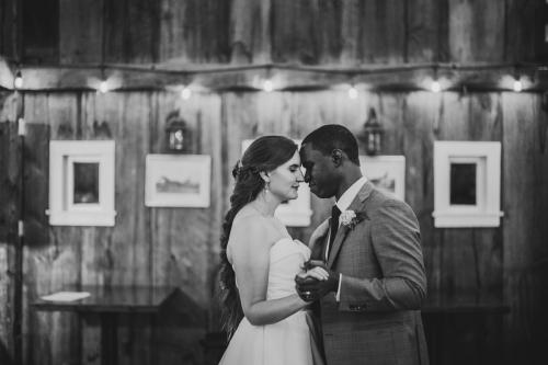A Western MA Wedding Photographer captures a bride and groom's first dance in a barn.