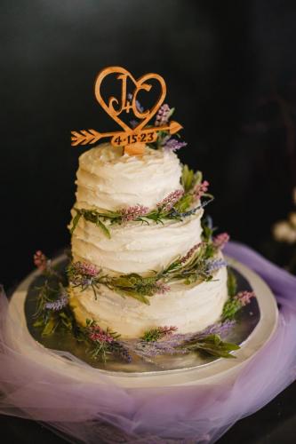 A heart shaped wedding cake with a Western MA Wedding Photographer capturing the special moment.