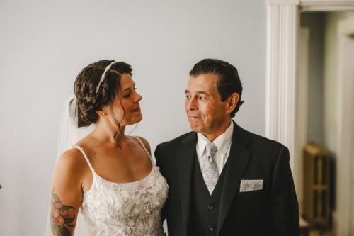 Western MA Wedding Photographer capturing the emotional exchange between a bride and her father as they lovingly lock eyes.