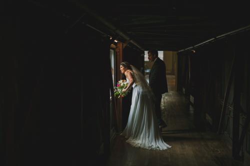 Western MA Wedding Photographer capturing a bride and groom in a dark hallway.