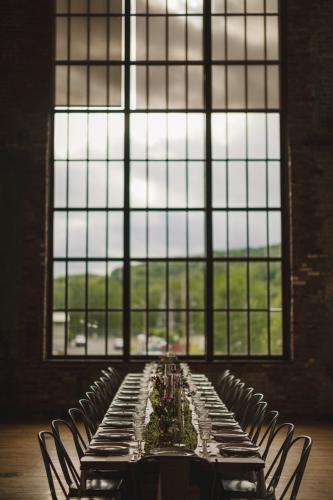 A Western MA Wedding Photographer sets up a table in front of a large window.