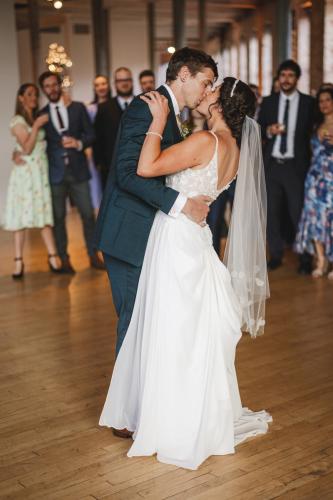 A Western MA Wedding Photographer captures the intimate first dance of a bride and groom in a warehouse.