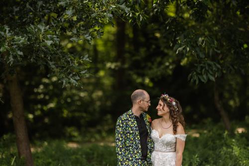 A bride and groom standing in the woods captured by a Western MA Wedding Photographer.