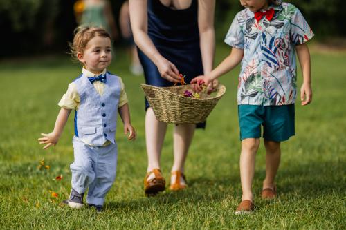 A woman and a boy holding baskets, captured in the best of 2023 wedding photography.