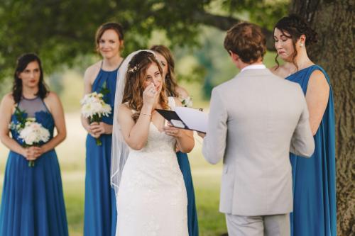 Western MA Wedding Photographer captures a heartfelt moment as a bride reads her vows to her bridesmaids.