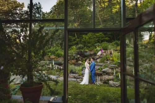 A Western MA Wedding Photographer capturing a couple standing in a botanical garden.