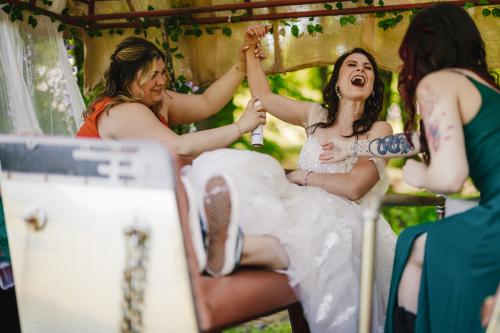 A Western MA wedding photographer captures the bride and her bridesmaids having a good time on a horse.
